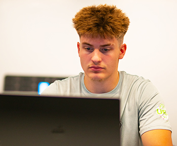 Student focused on laptop