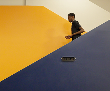 Student walking down stairs inside campus
